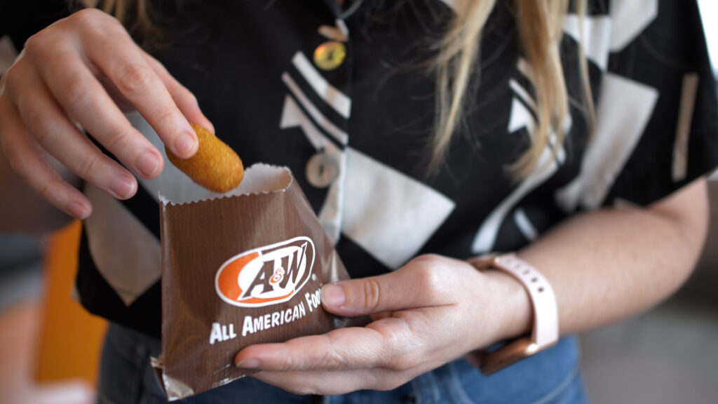 Customer with food in hands A&W restaurant franchise